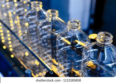 Bottle. Industrial production of plastic pet bottles. Factory line for manufacturing polyethylene bottles. Transparent food packaging.