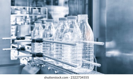 Bottle. Industrial production of plastic pet bottles. Factory line for manufacturing polyethylene bottles. Transparent food packaging. - Powered by Shutterstock