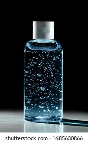 Bottle Of Instant Antiseptic Hand Sanitizer Transparent Gel Isolated On Black Background, No Label.  Antibacterial, Hydro Alcoholic Gel, Ethyl Alcohol. Mini Travel Pocket Small Size, 8 Fl Oz, 50, 60 M