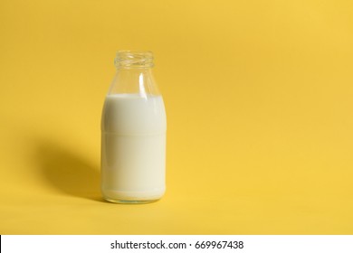 A bottle or jug of milk in pop art style with yellow background.