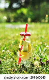 Bottle of lemonade in grass