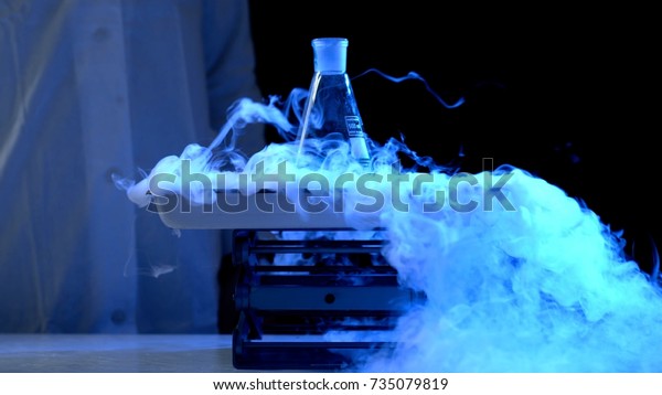 Bottle
and liquid nitrogen in a laboratory. Chemical experiment. Flask
with water and dry ice boiling chemical
experiment