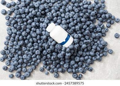 Bottle with medicine on the background of a large blueberry - Powered by Shutterstock