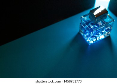 Bottle Of Men's Fragrance On A Dark Blue Background