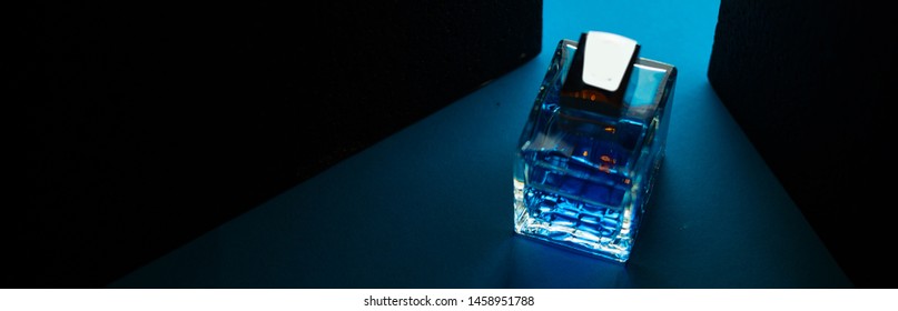 Bottle Of Men's Fragrance On A Dark Blue Background