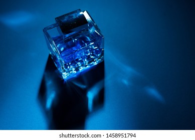 Bottle Of Men's Fragrance On A Dark Blue Background