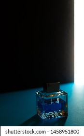 Bottle Of Men's Fragrance On A Dark Blue Background