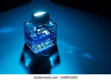 Bottle Of Men's Fragrance On A Dark Blue Background