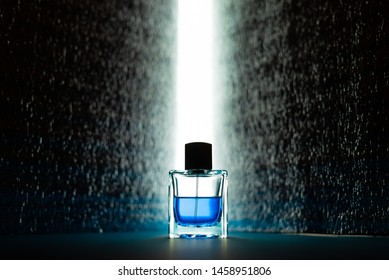 Bottle Of Men's Fragrance On A Dark Blue Background