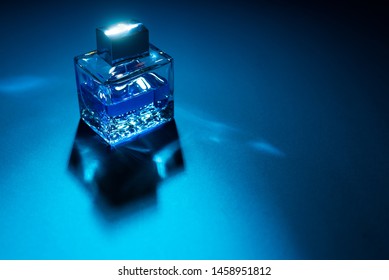 Bottle Of Men's Fragrance On A Dark Blue Background