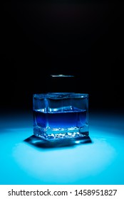 Bottle Of Men's Fragrance On A Dark Blue Background