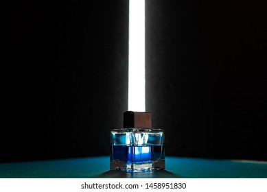 Bottle Of Men's Fragrance On A Dark Blue Background