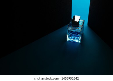 Bottle Of Men's Fragrance On A Dark Blue Background