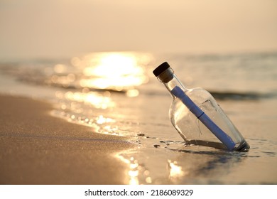 Bottle with a message on sea or ocean beach. Hope concept - Powered by Shutterstock