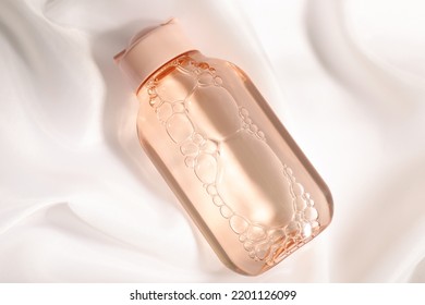 Bottle Of Micellar Water On White Fabric