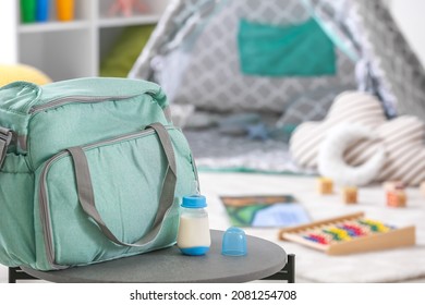 Bottle Of Milk For Baby With Bag On Table In Room