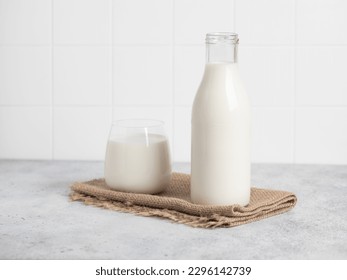 Bottle of milk, glass of milk. Modern white kitchen. - Powered by Shutterstock