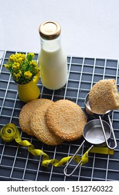 A Bottle Of Milk And Low Calories Sesame Biscuits With Measuring Tape: Healthy Lifestyle Concept (selective Focus Image)