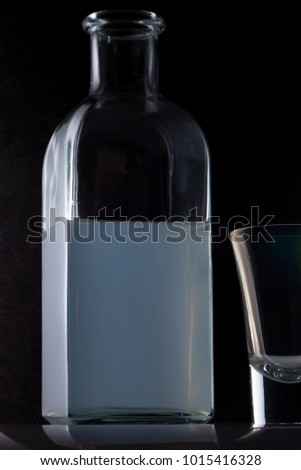 bottle of moonshine and a pile on a black background