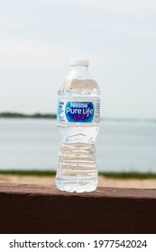 Bottle With Nestle Pure Life Water Outside In Sunny Day On Waterfront