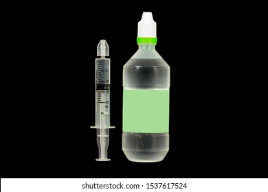 A Bottle Of Normal Saline With Syringe