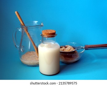 Bottle With Oat Milk. Used Pitcher And Strainer With Oat Flakes. Making Homemade Oat Milk