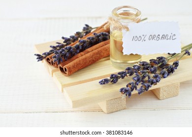 Bottle of oil with handwritten tag organic, dried lavender, cinnamon sticks