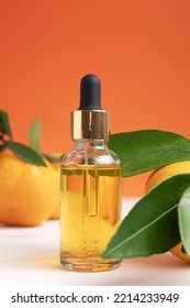 Bottle Of Orange Essential Oil For Aromatherapy. Orange Essential Oil. Citrus Essential Oil On Friut Background