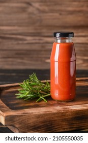 Bottle With Organic Tomato Sauce On Wooden Background