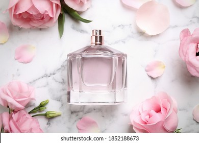 Bottle Of Perfume, Beautiful Flowers And Petals On White Marble Table, Flat Lay