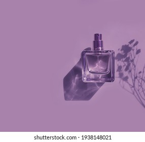 Bottle Of Perfume On A Colored Background Shadow