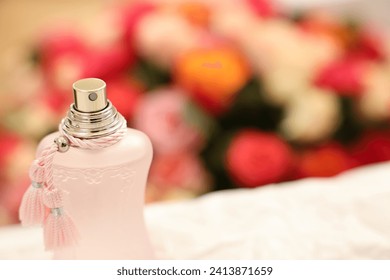 Bottle of perfume on crumpled paper against beautiful roses, closeup. Space for text - Powered by Shutterstock