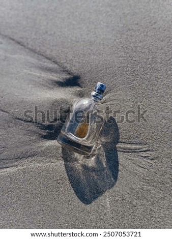 A bottle perfume Stranded on beach