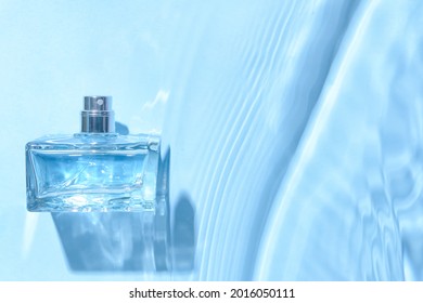 Bottle of perfume in water on color background - Shutterstock ID 2016050111
