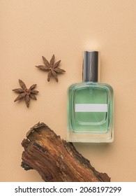 A Bottle Of Perfumed Water, Wood And Star Anise On A Beige Background. The Concept Of Natural Cosmetics. Flat Lay.