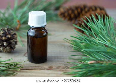 Bottle Of Pine Essential Oil On Wooden Table