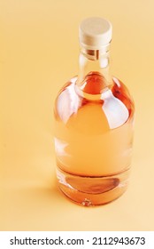 A Bottle Of Pink Gin, On A Light Colored Background