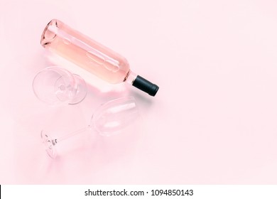 Bottle Of Pink Wine And Two Glasses Of Wine On A Soft Light Pink Wood Table, Mock Up. Flat Lay, Top View, Copy Space