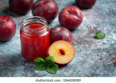 A Bottle Of Plum Jam  Put On Dark Floor