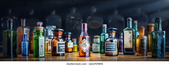 A Bottle Of Poison On A Background Of Old Medical, Chemistry And Pharmacy Glass. Chemistry And Pharmacy History Panoramic Concept Background. Retro Style.