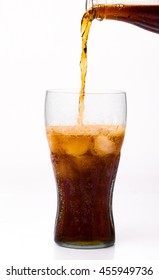 Bottle Pouring Coke In Drink Glass With Ice Cubes