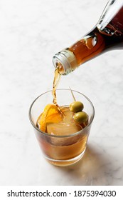 Bottle Pouring Red Vermouth Into A Glass