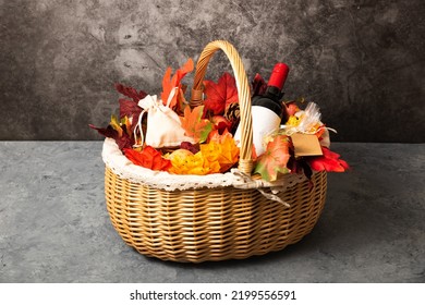 Bottle Of Red Wine With Apples And Cookies In A Gift Basket. Hamper For Autumn Thanksgiving Festival