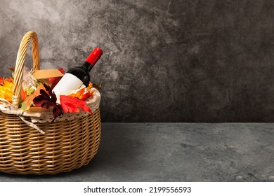 Bottle Of Red Wine With Apples And Cookies In A Gift Basket. Hamper For Autumn Thanksgiving Festival