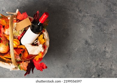 Bottle Of Red Wine With Apples And Cookies In A Gift Basket. Hamper For Autumn Thanksgiving Festival