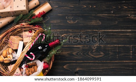 Bottle of red wine in Christmas basket.