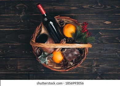 Bottle Of Red Wine In Christmas Gift Basket.