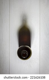 Bottle Of Red Wine With Cork On White Wooden Table. Top View