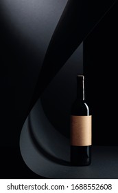 Bottle Of Red Wine With Empty Paper Label On A Black Background. Copy Space.