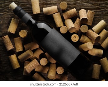 A Bottle Of Red Wine Lies On Wine Corks. Large Group Of Objects. Restaurant, Hotel, Bar, Wine Cellar, Tasting, Sommelier. Background, Wallpaper, Texture. There Are No People In The Photo.